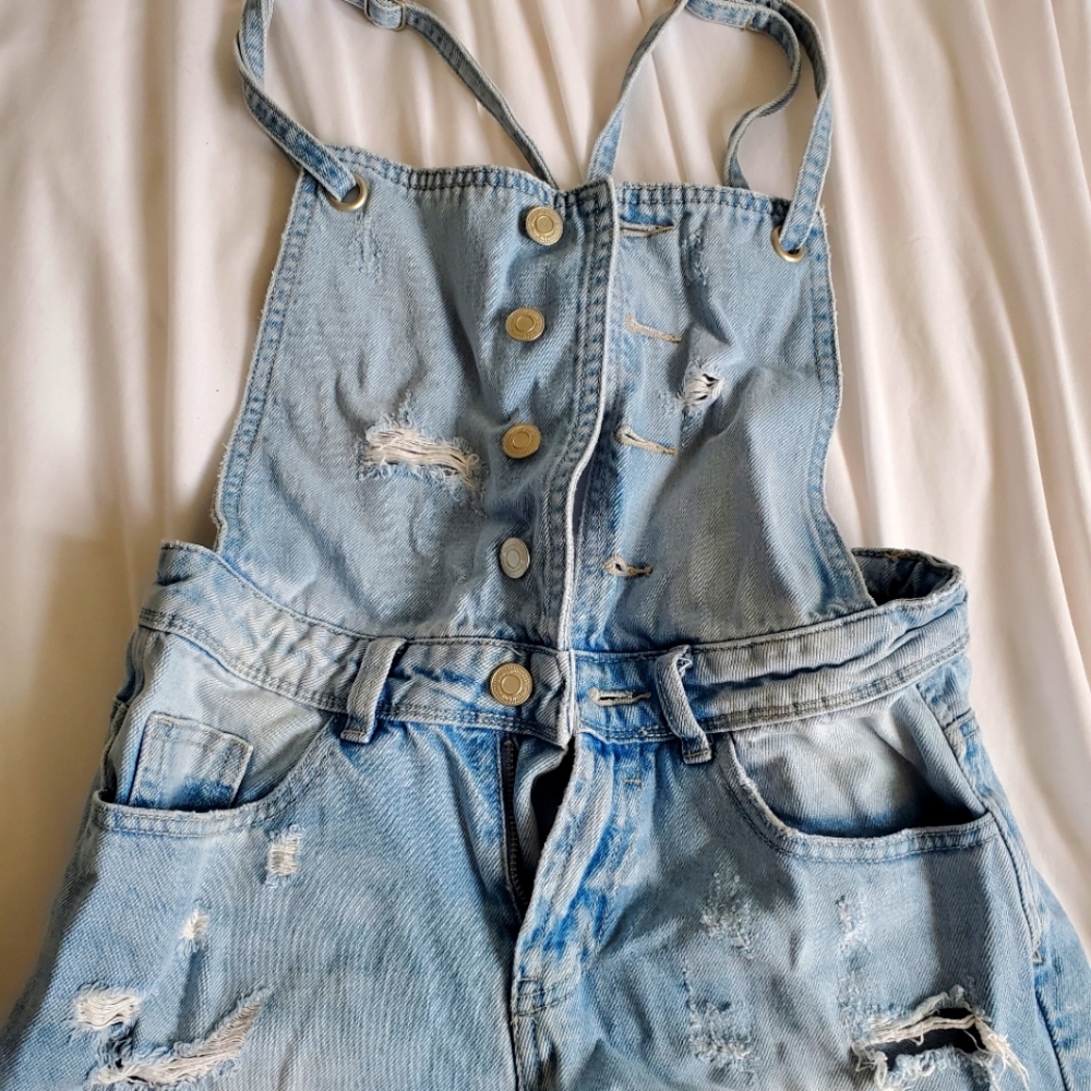 Distressed denim overalls